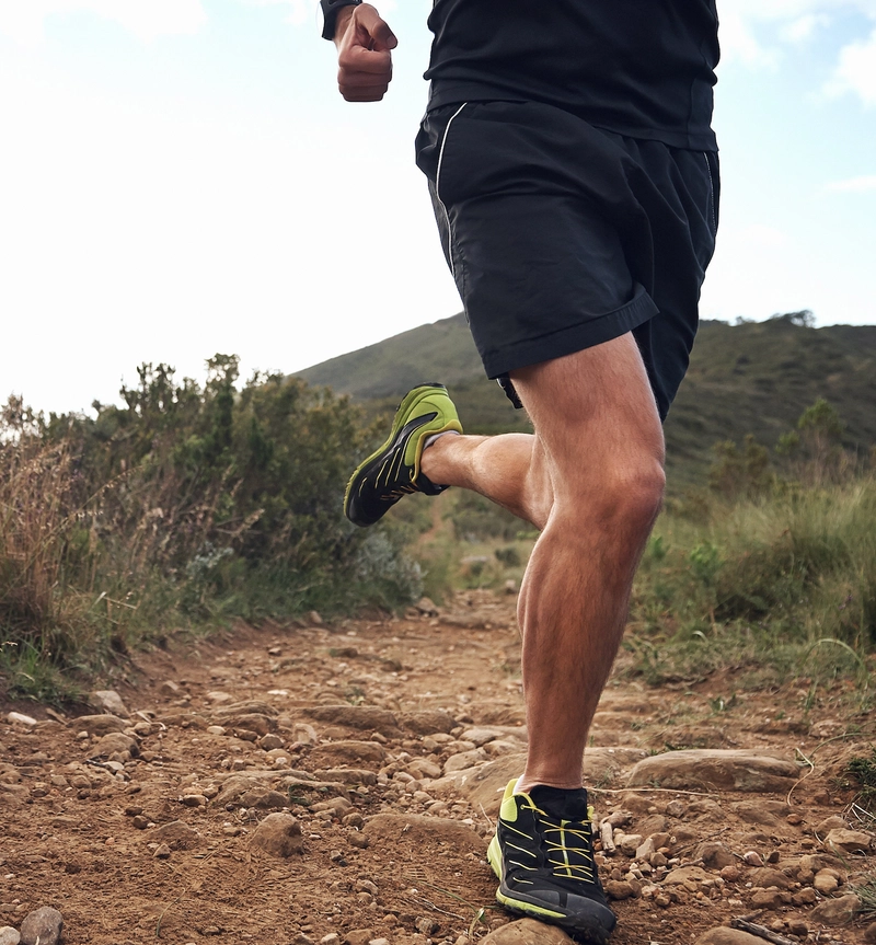 Athletic man running on a trail