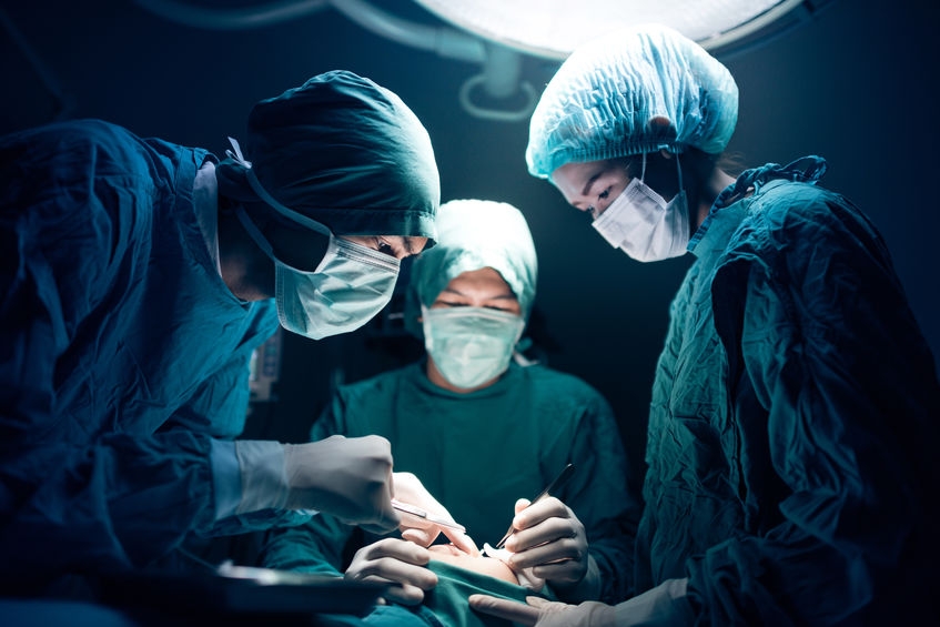 surgeons operating on patient